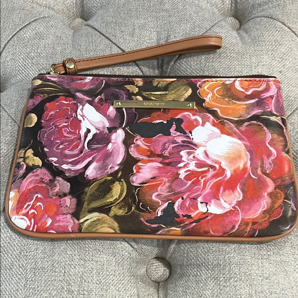 Brahmin Daisy wristlet featuring a floral design.